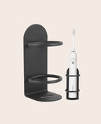 No-drill wall holder for an electric toothbrush and razor, shown mounted in a bathroom