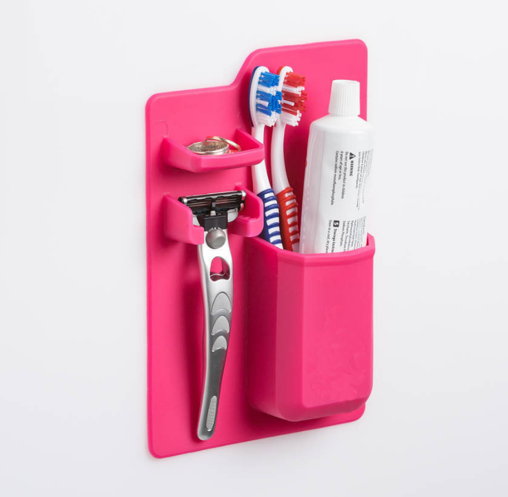 Multi-functional toothbrush holder beside a bathroom basin