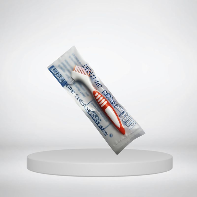 Travel denture toothbrush showing its soft-bristle head