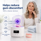 Ultrasonic denture cleaner beside a set of removable dentures