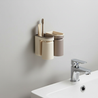 Toothbrush holder and cup attached to a bathroom wall