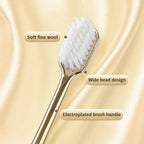 Adult toothbrush with a sleek silver handle and soft bristles