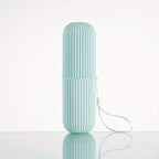 Travel oral care case displayed with a toothbrush and tongue scraper