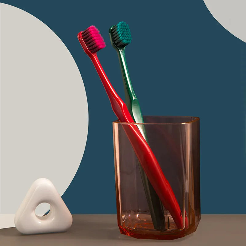 Wide-head soft toothbrush with ultra-fine bristles on a plain background
