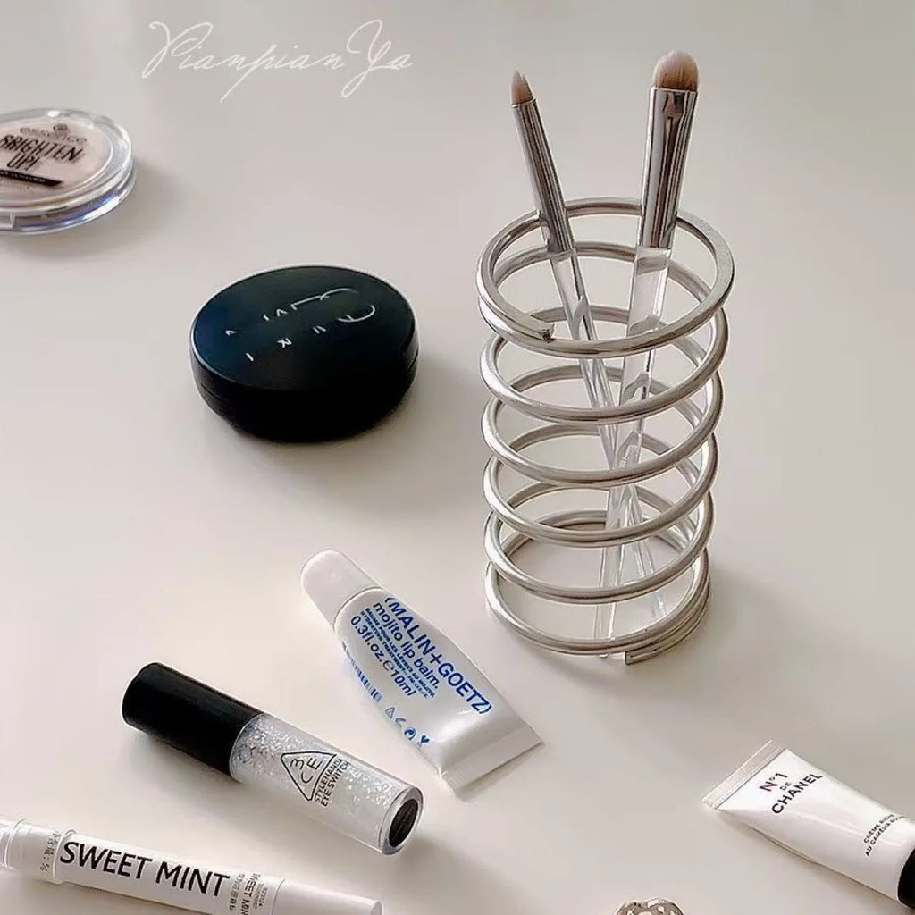 Toothbrushes stored neatly in a stainless steel holder
