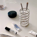 Toothbrushes stored neatly in a stainless steel holder