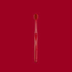 Single soft toothbrush shown from the side with its wide head