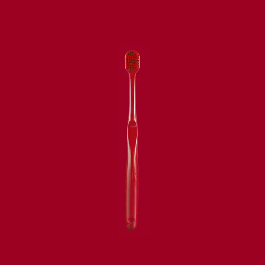 Single soft toothbrush shown from the side with its wide head