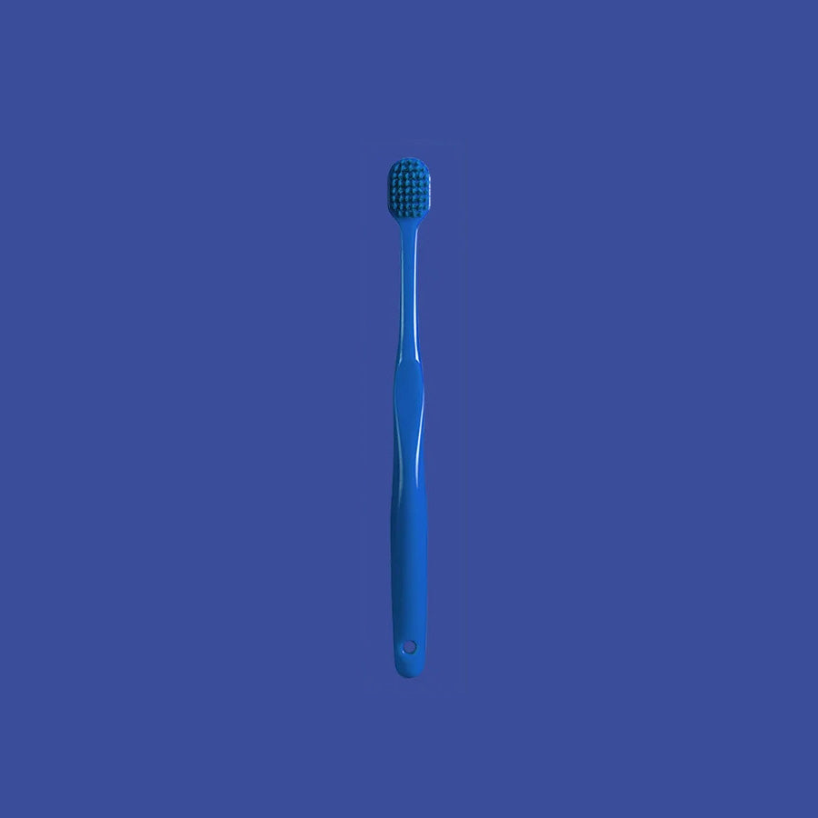 Manual toothbrush for daily adult oral hygiene with a gentle brush