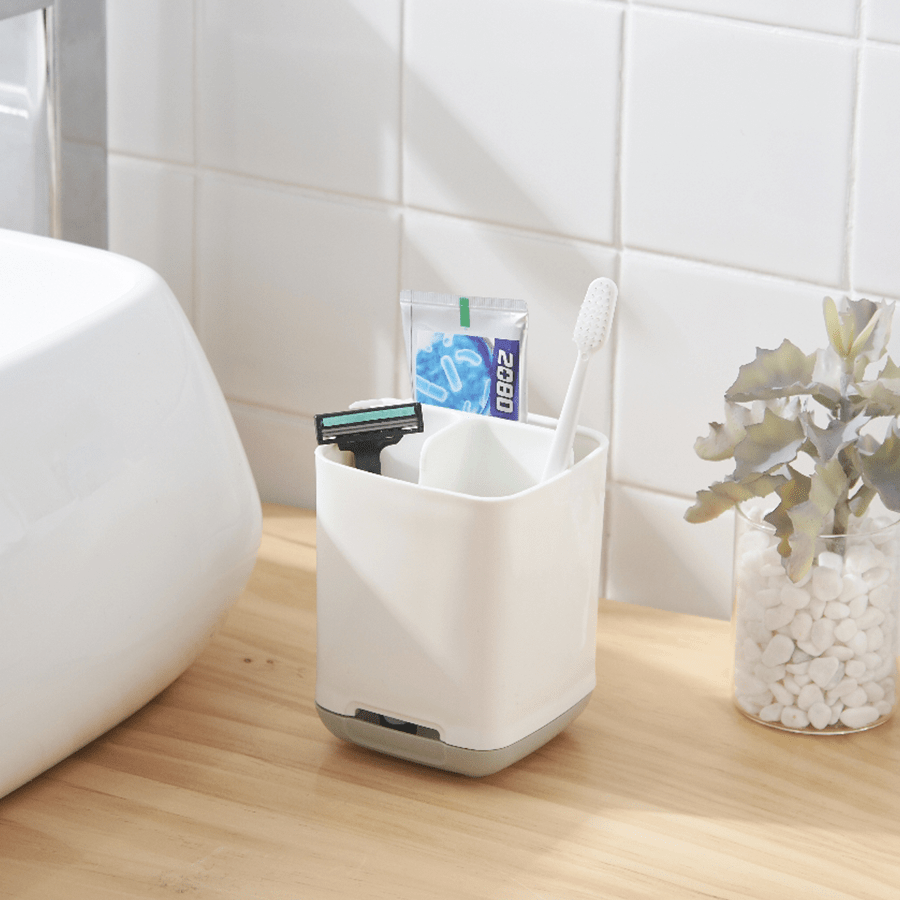 Grey bathroom organiser holding toothbrushes on a bathroom countertop