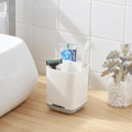 Grey bathroom organiser holding toothbrushes on a bathroom countertop